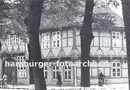 11_21487 historische Aufnahme von alten Gasthof Stadt Hamburg ca. 1936 - hohe Linden stehen an der Strasse, Passanten gehen auf dem Brgersteig oder schieben ihr Fahrrad vor dem Fachwerkgebude. Das ca. 1550 errichtete Gasthaus hat aufwndige Schnitzerein im Fachwerk. www.hamburger-fotoarchiv.de
